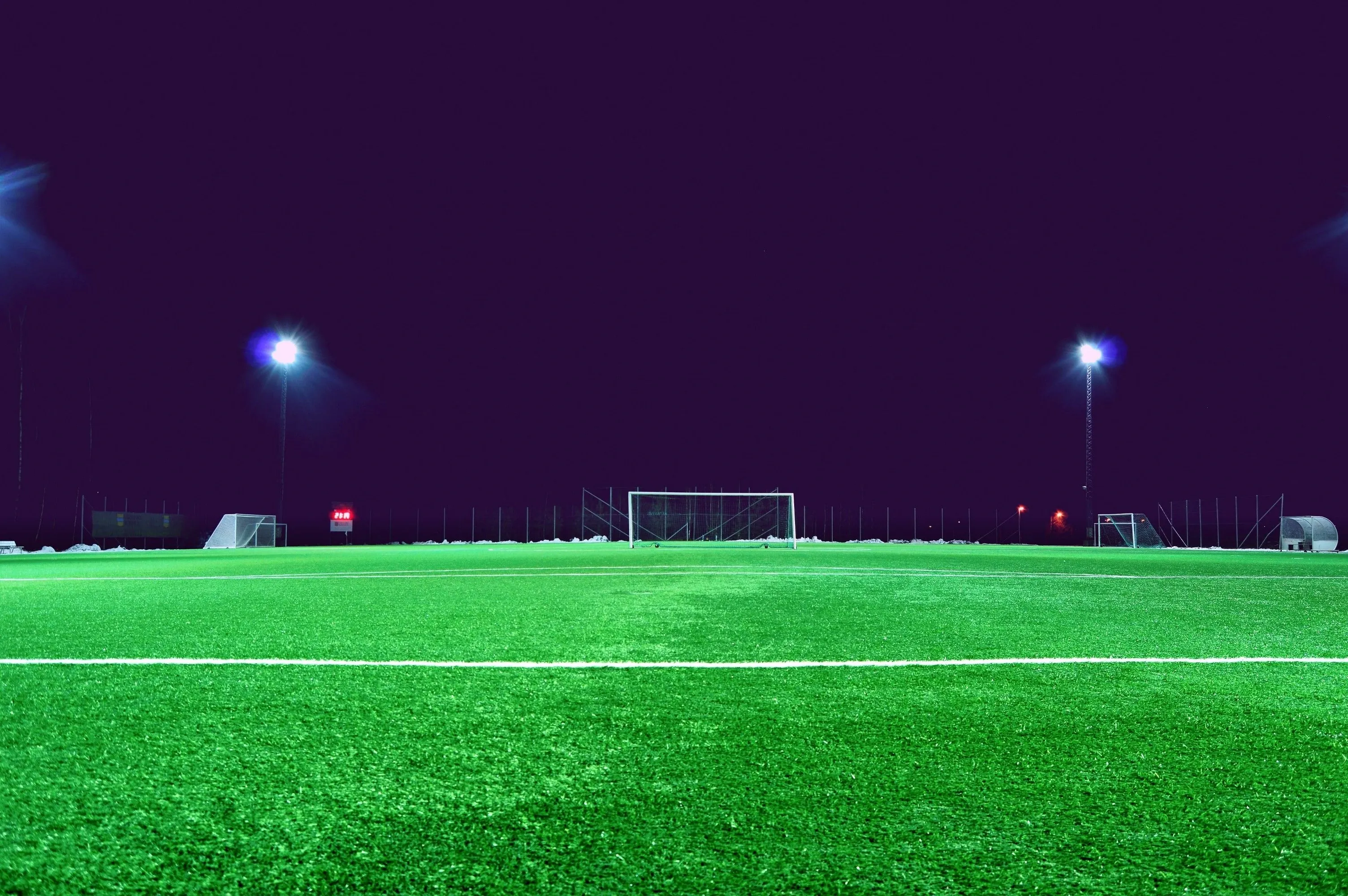 Sports field floodlights illuminated at night