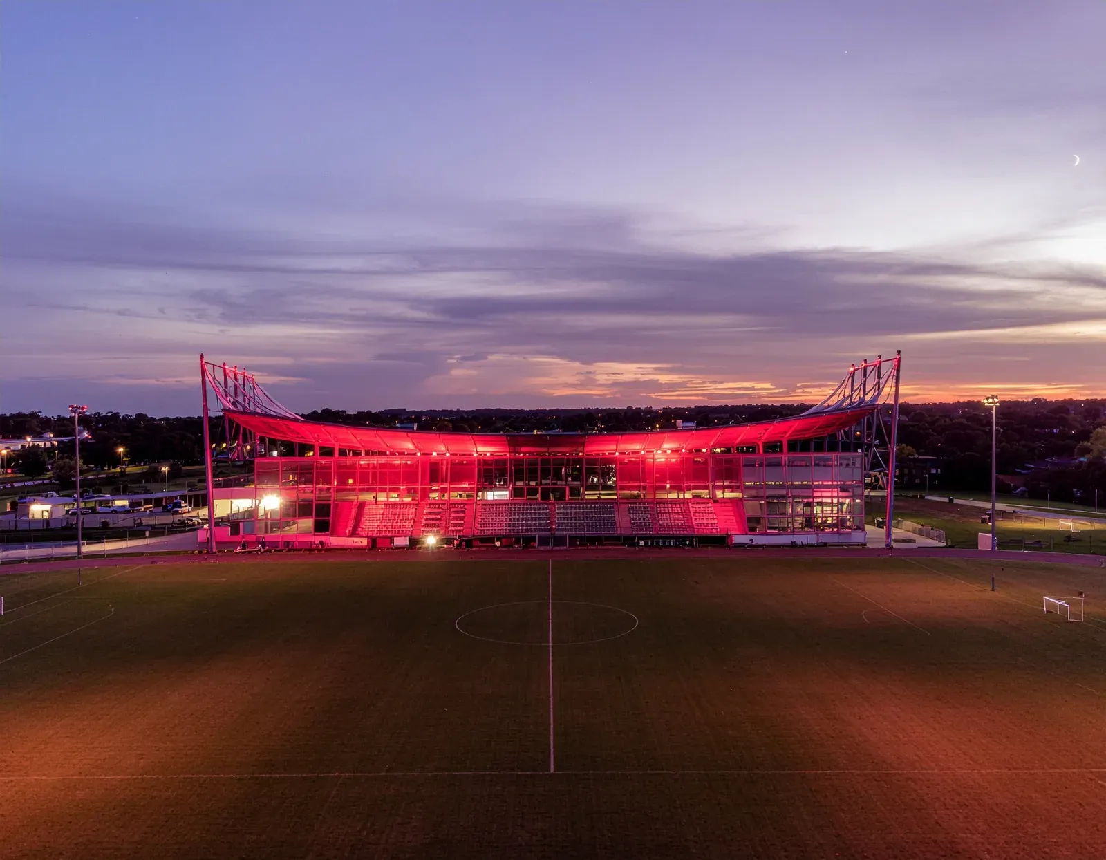 Sports field floodlights illuminated at night
