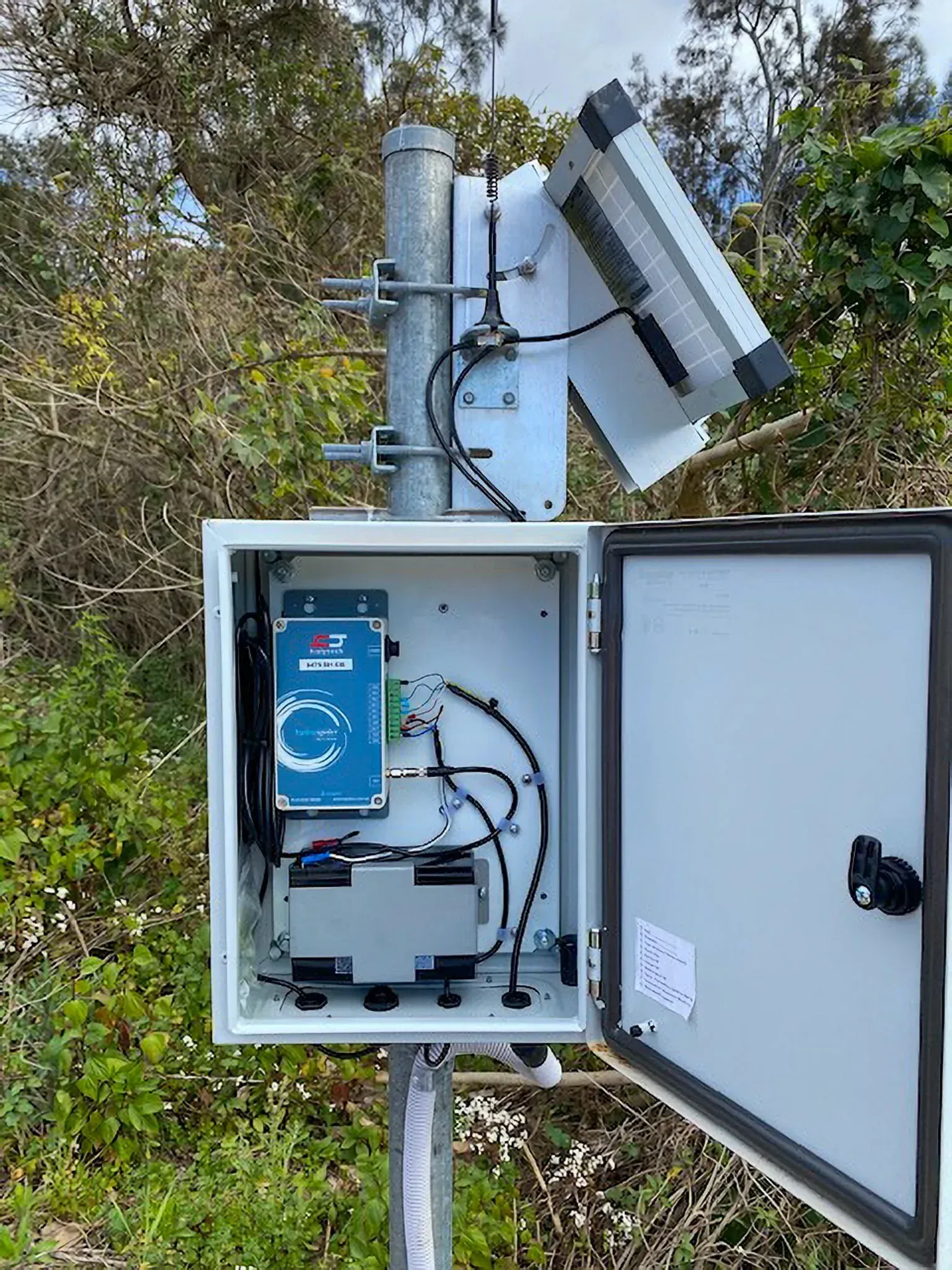 HydroSpider 2 in a field enclosure with solar panel
